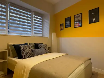 a bedroom with a bed and a yellow wall at Stunning 2BR 2Bath near Metro - YM 1 in Istanbul