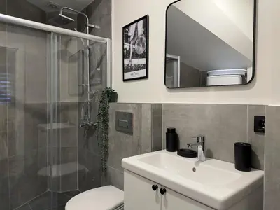 a bathroom with a sink and a toilet and a mirror at Stunning 2BR 2Bath near Metro - YM 1 in Istanbul