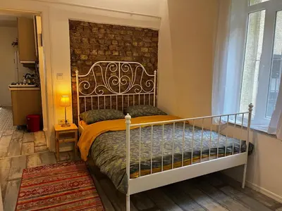 a bedroom with a bed and a brick wall at Taksim Apartment in Istanbul