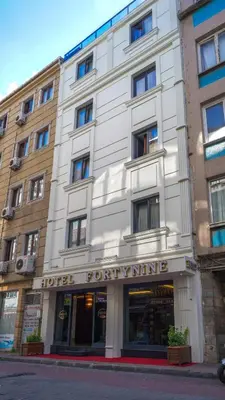 a white building on a street with a store at Hotel FORTYNİNE in Istanbul