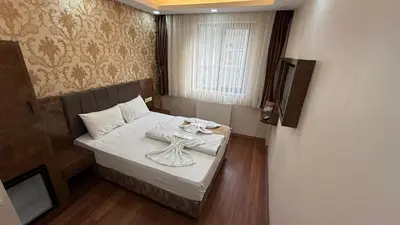 a small room with a bed and a television at Hotel FORTYNİNE in Istanbul