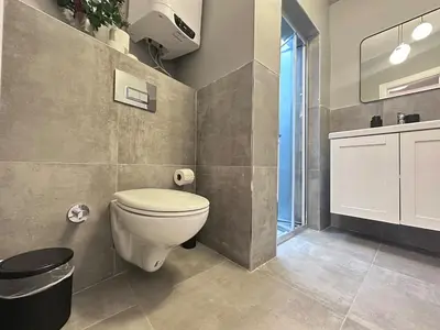 a bathroom with a white toilet and a window at Stunning Apt Near Metro - YM 2 in Istanbul