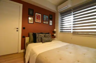 a bedroom with a large bed with a window at Stunning Apt Near Metro - YM 2 in Istanbul