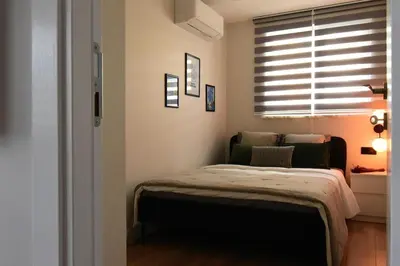 a small bedroom with a bed and a window at Stunning Seaview 2BR near Metro - YM5 in Istanbul