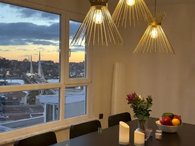 a dining room with a table and two lights at Stunning Seaview 2BR near Metro - YM5 in Istanbul