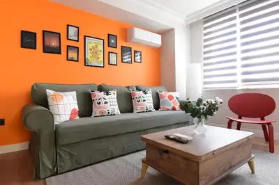 a living room with a green couch and an orange wall at Stunning Seaview 2BR near Metro - YM5 in Istanbul