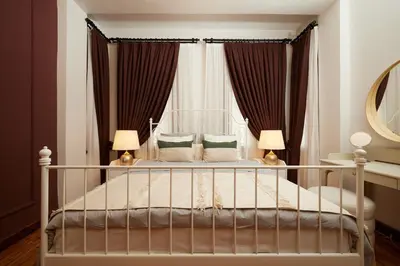 a bedroom with a bed with two lamps and a mirror at Spacious 2BR w AC Lift in Taksim - Kurabiye D2 in Istanbul