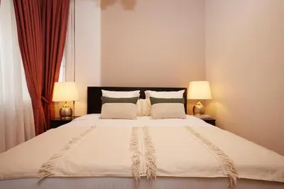 a bedroom with a large white bed with two lamps at Taksim Square - Unique Loft for 12 Guests in Istanbul