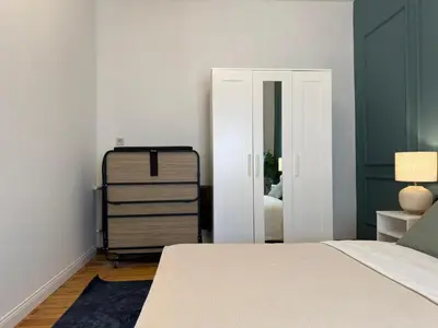 a bedroom with a bed and a dresser and a mirror at Taksim Square - Unique Loft for 12 Guests in Istanbul