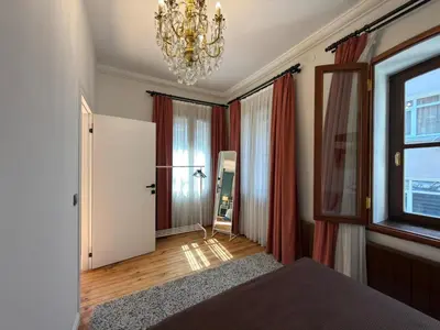 a bedroom with a bed and a chandelier at Taksim Square - Unique Loft for 12 Guests in Istanbul