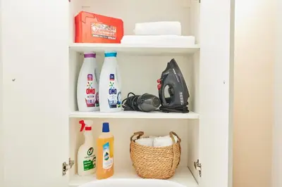 a shelf with bottles and a basket in a bathroom at Stunning 3BR 3Bathroom 3AC near Metro D1 in Istanbul