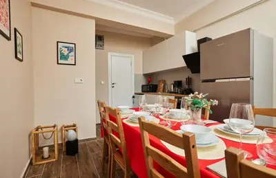 a dining room with a red table and chairs at Stunning 3BR 3Bathroom 3AC near Metro D2 in Istanbul