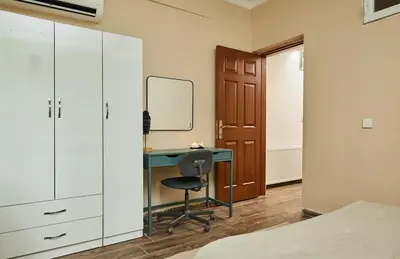 a bedroom with a desk with a chair and a mirror at Stunning 3BR 3Bathroom 3AC near Metro D2 in Istanbul