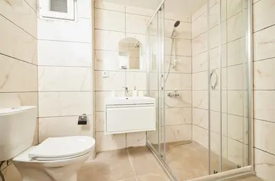 a bathroom with a toilet and a shower at Stunning 3BR 3Bathroom 3AC near Metro D2 in Istanbul