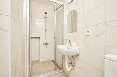 a white bathroom with a sink and a shower at Stunning 3BR 3Bathroom 3AC near Metro D2 in Istanbul