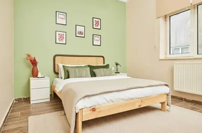 a bedroom with a bed with green walls and a window at Stunning 3BR 3Bathroom 3AC near Metro D3 in Istanbul