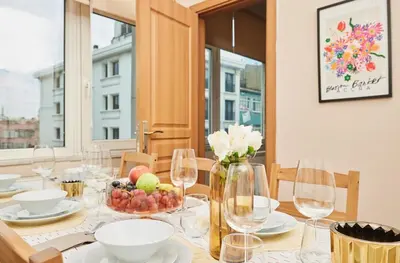 a table with wine glasses and a vase of fruit at Stunning 3BR 3Bathroom 3AC near Metro D4 in Istanbul
