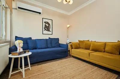 a living room with a blue couch and a table at Stunning 3BR 3Bathroom 3AC near Metro D5 in Istanbul
