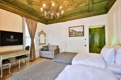 a bedroom with a bed and a desk and a chair at Emerald Mansion Hotel in Istanbul