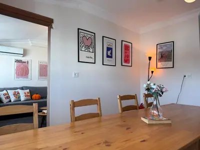 a living room with a table with a vase of flowers at Stunning 3BR 3Bathroom 3AC near Metro D6 in Istanbul