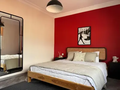 a bedroom with red walls and a bed with a mirror at Stunning 3BR 3Bathroom 3AC near Metro D6 in Istanbul