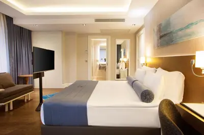 a hotel room with a large bed and a television at Veyron Hotels & SPA in Istanbul