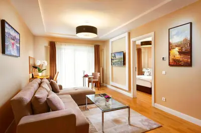 a living room with a couch and a table at Nidya Hotel Esenyurt in Istanbul