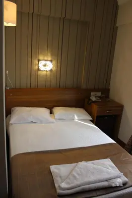 a bedroom with a bed with two towels on it at Grand Laleli Hotel in Istanbul