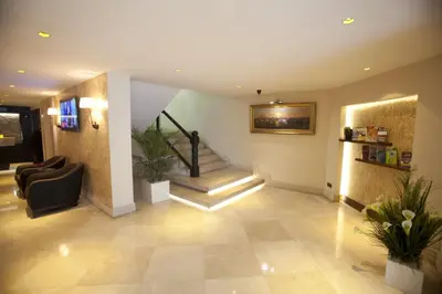 a lobby with a staircase in a building at Grand Laleli Hotel in Istanbul
