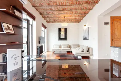 a living room with a couch and a glass table at Beautiful restored historical apartment in Galata in Istanbul