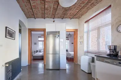 a kitchen with a stainless steel refrigerator in a room at Beautiful restored historical apartment in Galata in Istanbul