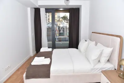 a bedroom with a white bed and a window at Yakut Suite in Istanbul