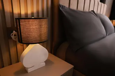 a lamp on a table next to a bed at World Yours Luxury Suite - Beyoğlu in Istanbul