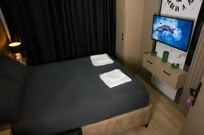 a small room with a bed and a tv at World Yours Luxury Suite - Beyoğlu in Istanbul