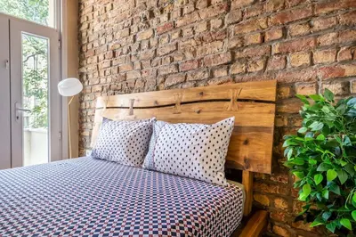 a bedroom with a brick wall and a bed with pillows at Classic Historical Galata Apartment in Istanbul