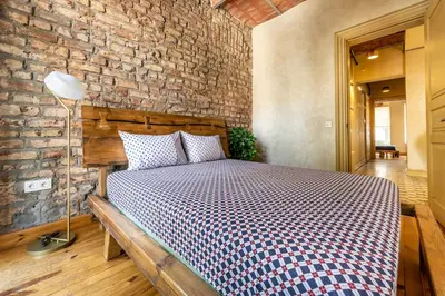 a bedroom with a bed with a brick wall at Classic Historical Galata Apartment in Istanbul