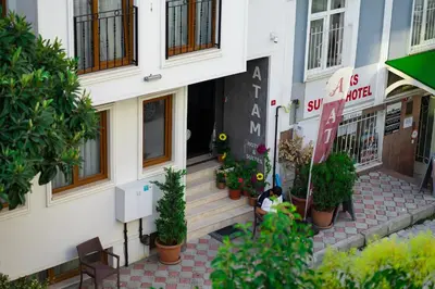 a woman sitting on the steps of a building at Atam Suites in Istanbul