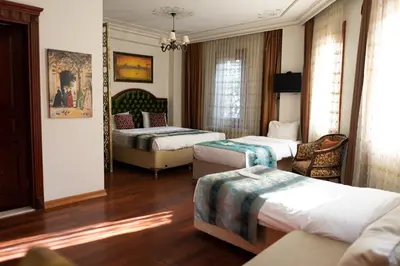 a hotel room with two beds and a couch at Atam Suites in Istanbul