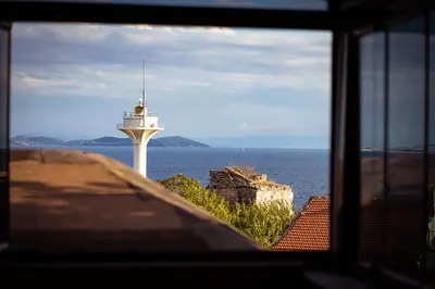 a view of a lighthouse from a window at Atam Suites in Istanbul