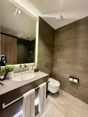 a bathroom with a sink and a toilet and a mirror at Cityloft 147 in Istanbul