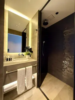 a bathroom with a sink and a shower with towels at Cityloft 147 in Istanbul