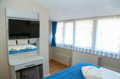 a small room with two beds and a tv at ASİTANE life HOTEL in Istanbul
