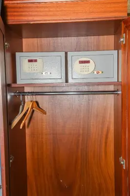 a wooden cabinet with two clocks on top of it at ASİTANE life HOTEL in Istanbul