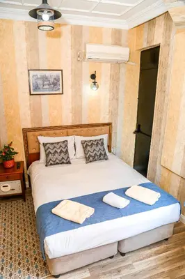 a bedroom with a bed with two towels on it at ASİTANE life HOTEL in Istanbul
