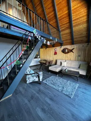 a living room with a staircase and a couch at DREAM DELUXE SAPANCa in Sapanca