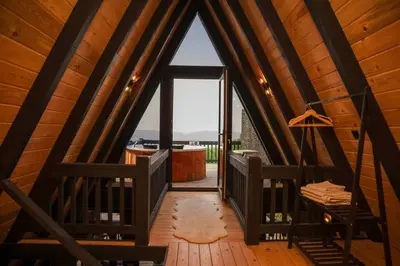 a room with a large window in a wooden cabin at Hill House Bungalov in Sapanca