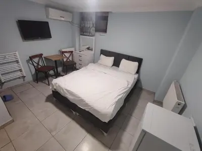 a bedroom with a bed and a table with chairs at Taksim Luxury Mansion Hotel in Istanbul