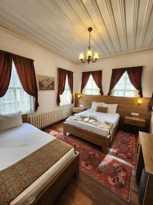 a bedroom with two beds and a ceiling at Kadıköy White House in Istanbul
