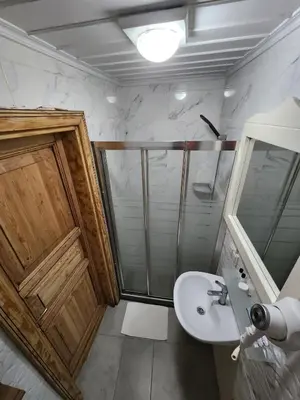 a bathroom with a shower and a sink at Kadıköy White House in Istanbul