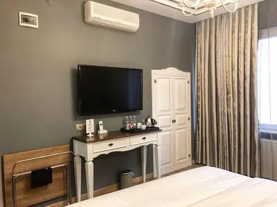a bedroom with a flat screen tv on a wall at My Dora Hotel in Istanbul